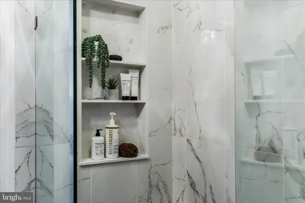 a view of bathroom with a potted plant on a sink and a mirror