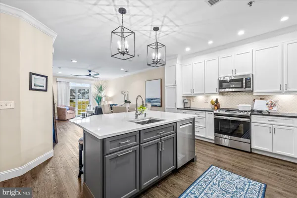 a kitchen with a sink stainless steel appliances and cabinets