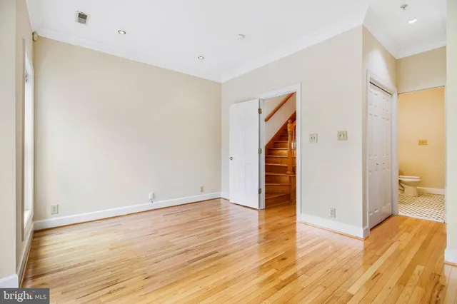 a kitchen with granite countertop white cabinets and stainless steel appliances