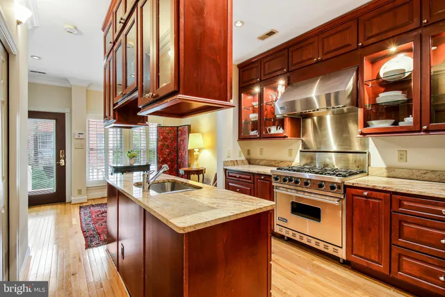 a kitchen with stainless steel appliances granite countertop a stove and a sink
