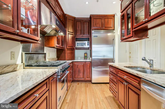 a living room with furniture a rug and a lamp