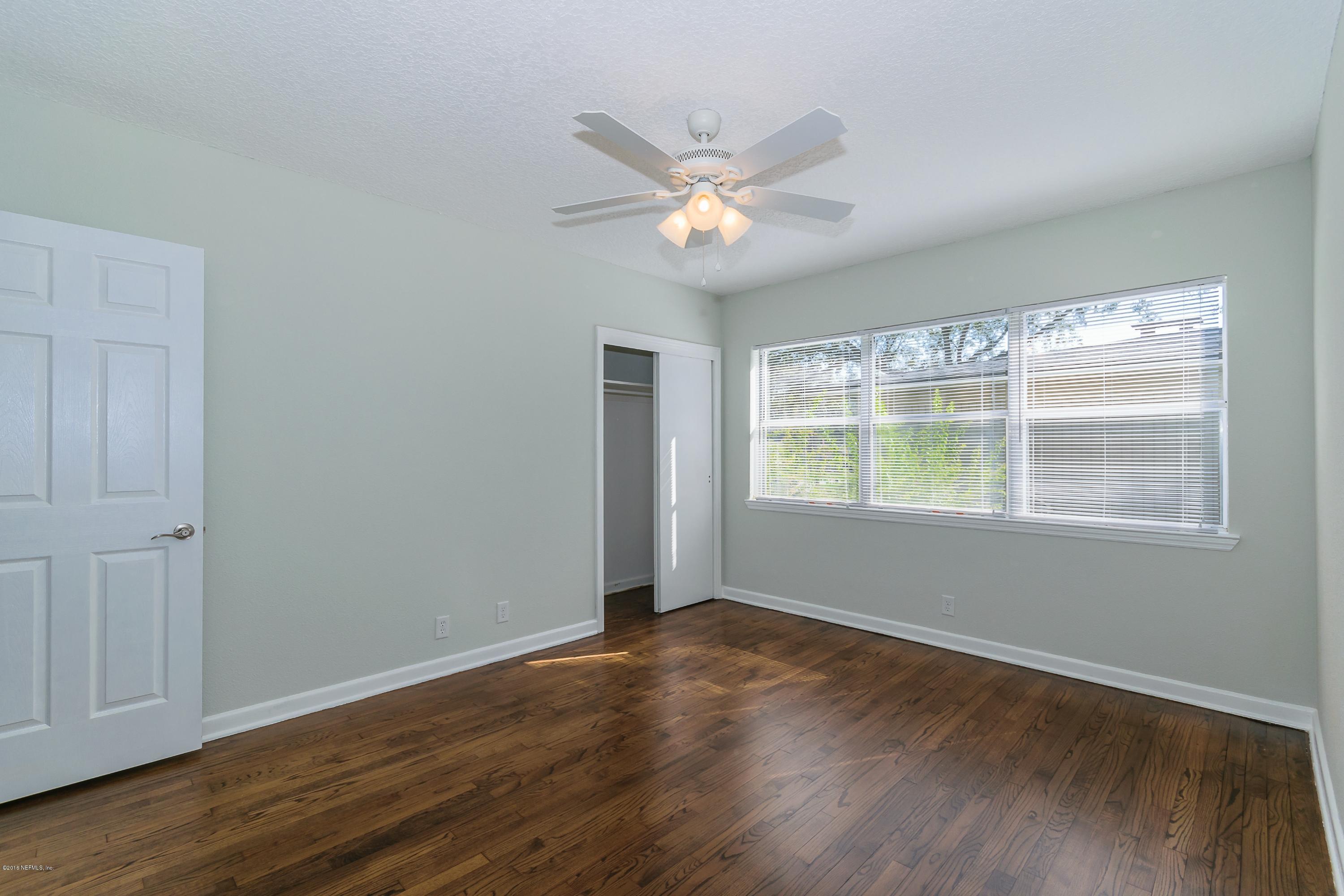6330 Wesleyan Road Jacksonville, FL 32217 - Photo 13 of 17 a view of an empty room with wooden floor and a window