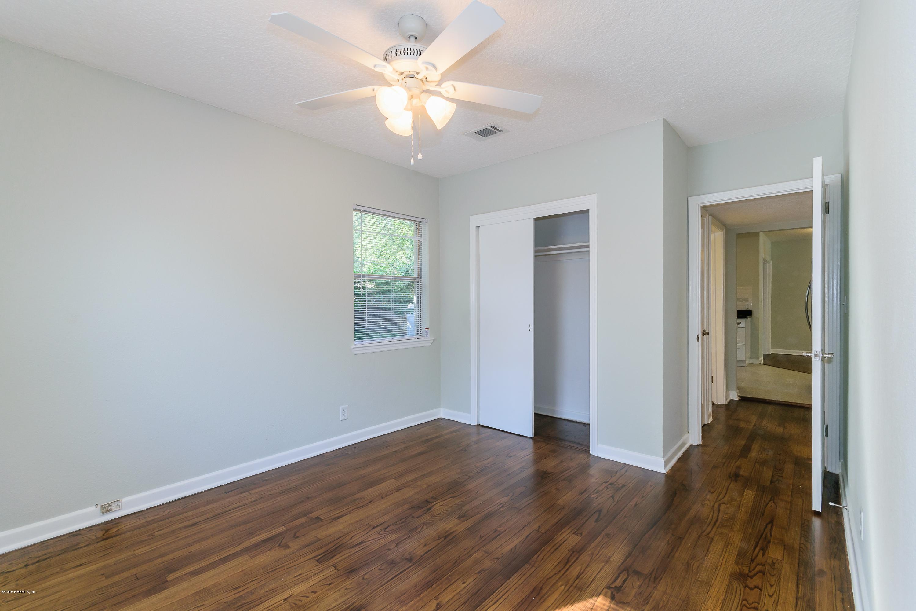 6330 Wesleyan Road Jacksonville, FL 32217 - Photo 14 of 17 an empty room with wooden floor and a ceiling fan
