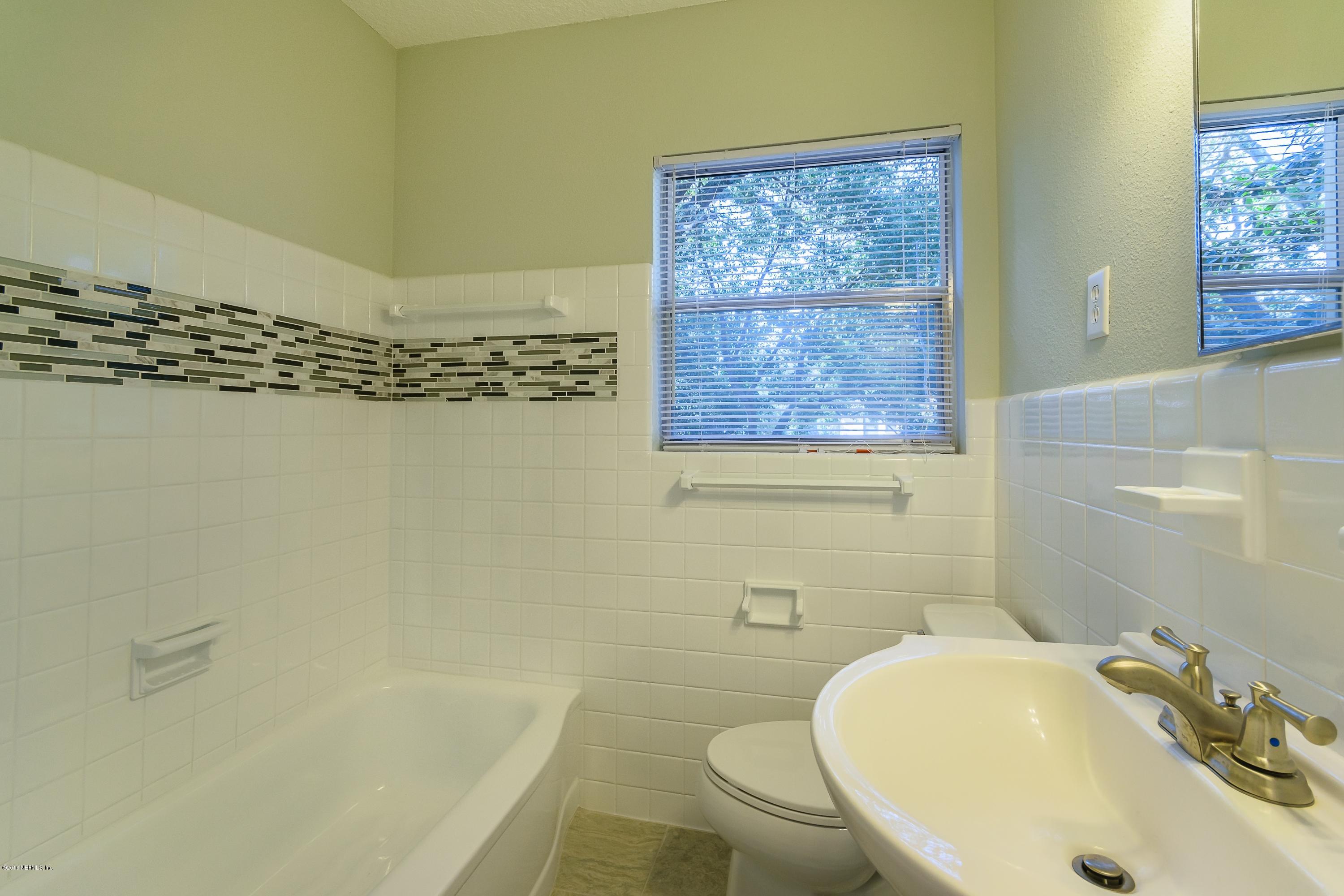 6330 Wesleyan Road Jacksonville, FL 32217 - Photo 15 of 17 a bathroom with a sink a bathtub and shower