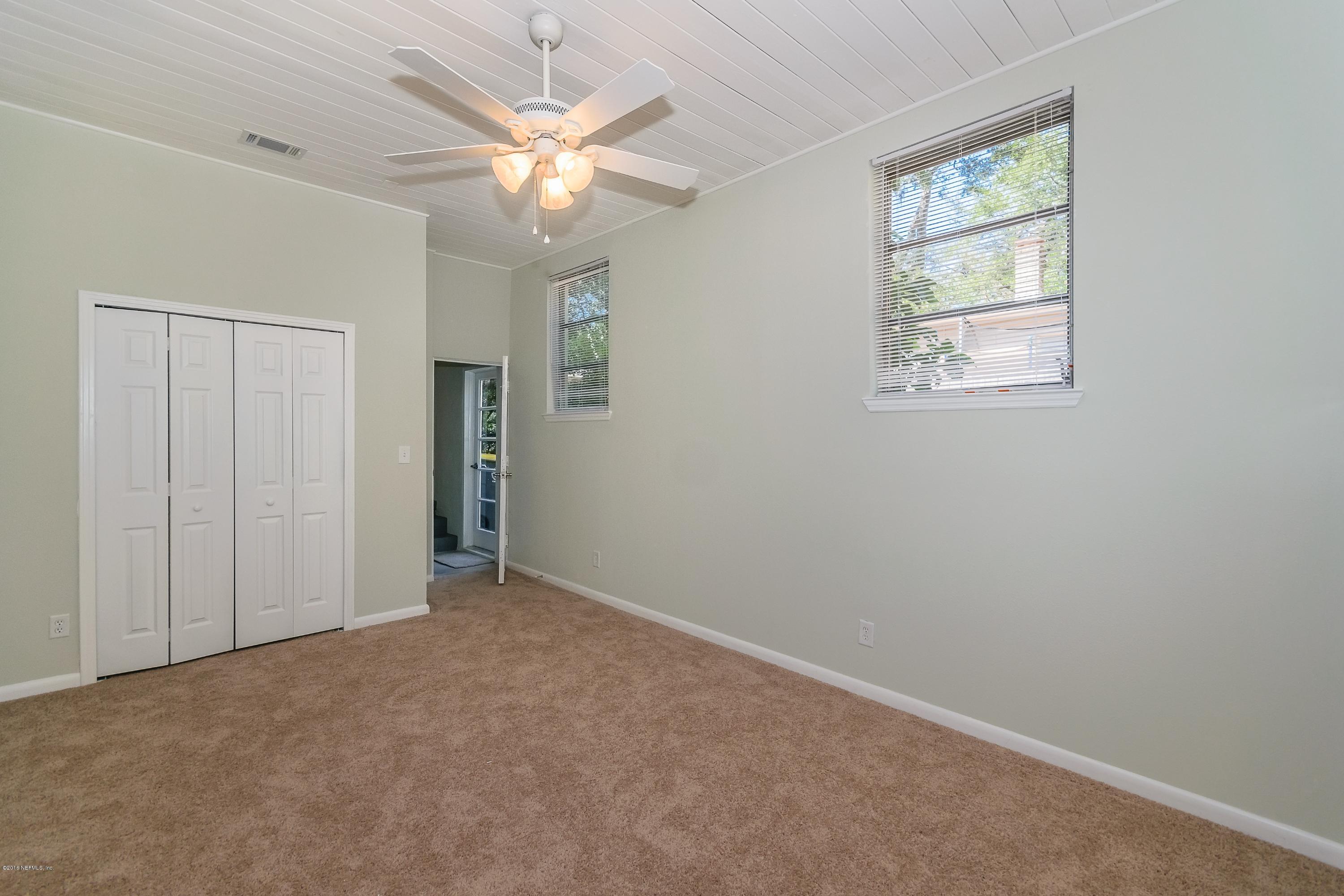 6330 Wesleyan Road Jacksonville, FL 32217 - Photo 16 of 17 an empty room with windows and fan
