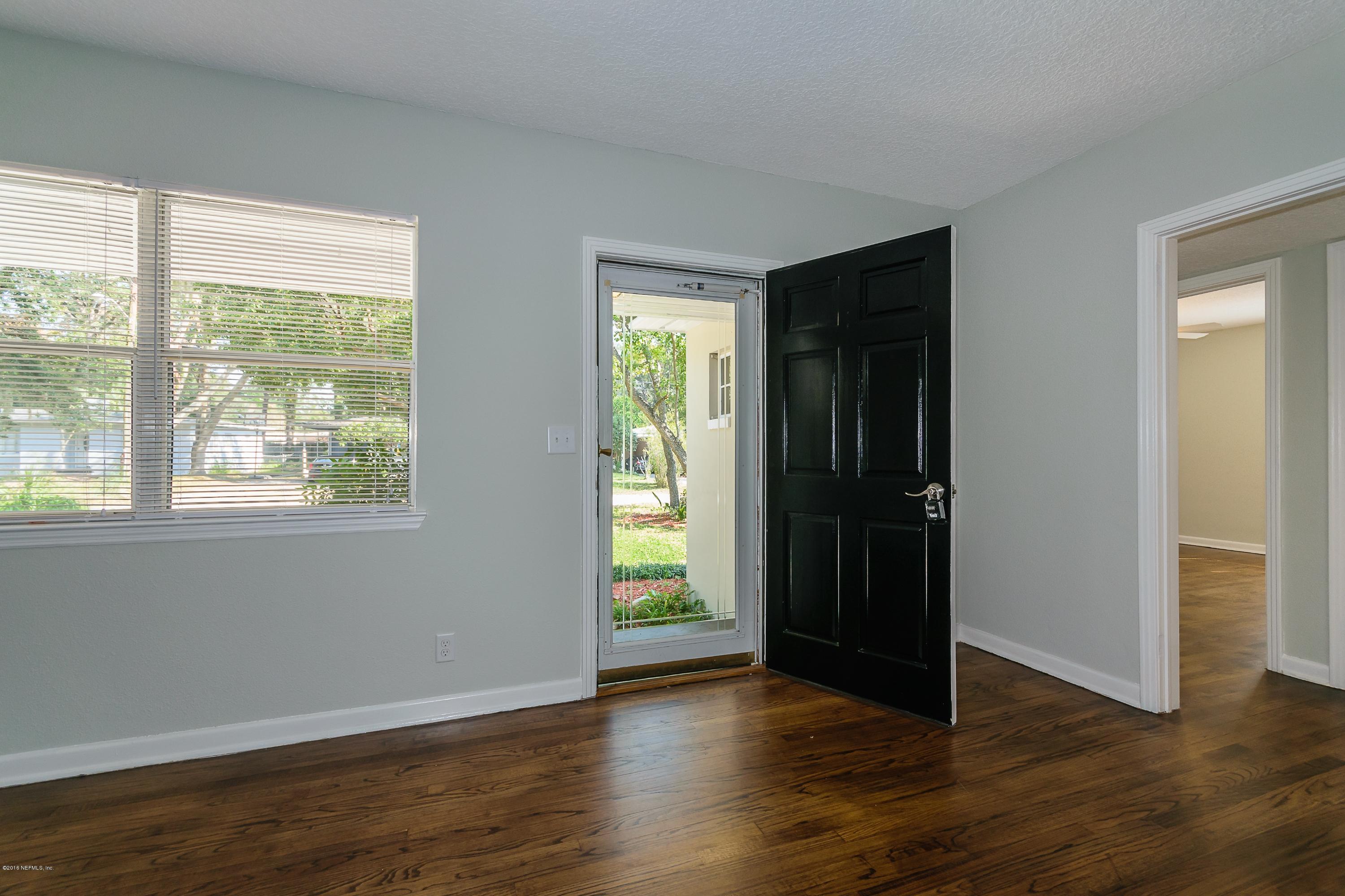 6330 Wesleyan Road Jacksonville, FL 32217 - Photo 4 of 17 a view of an empty room with wooden floor and a window