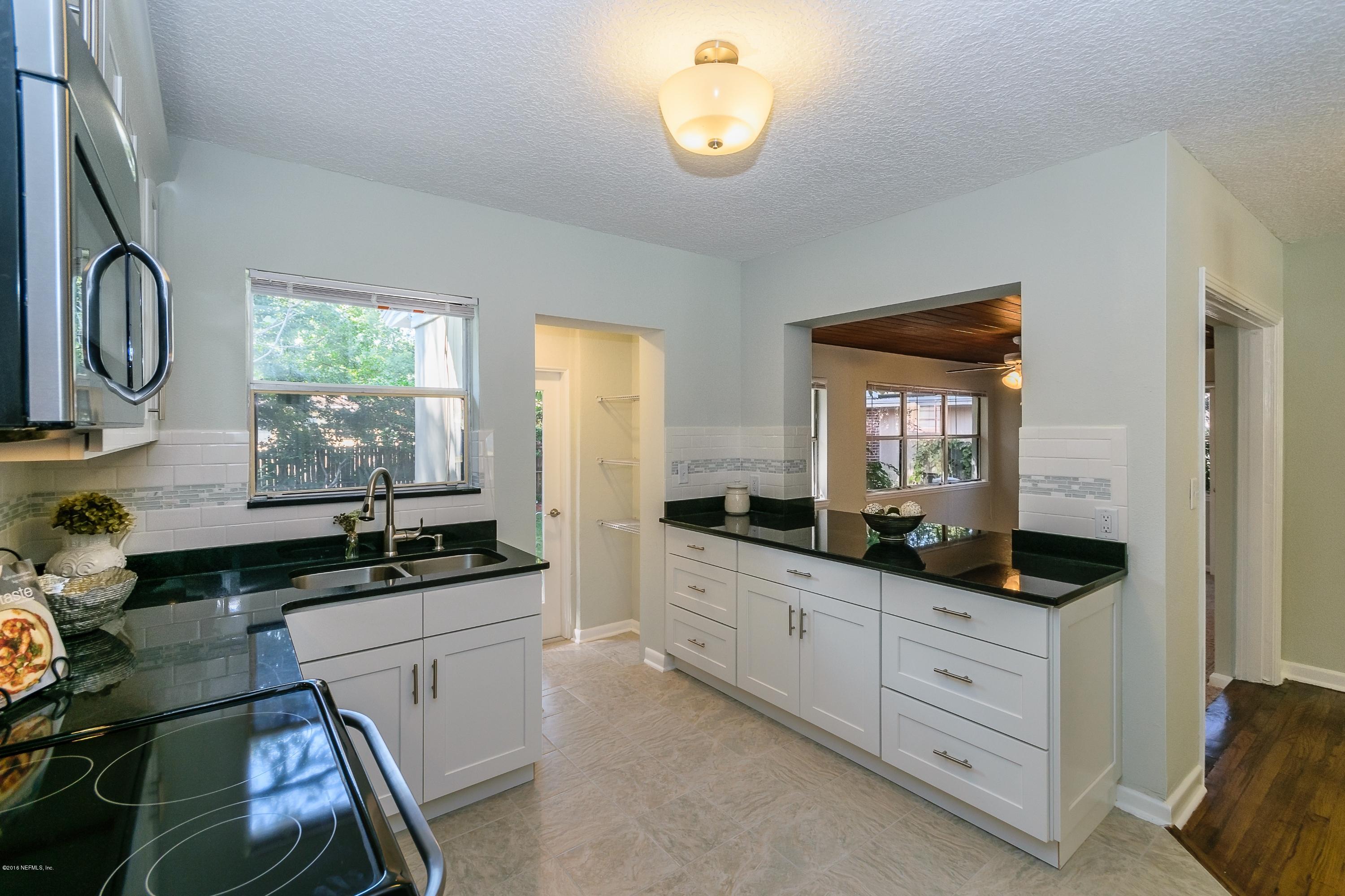 6330 Wesleyan Road Jacksonville, FL 32217 - Photo 7 of 17 a kitchen with a stove a sink and a refrigerator
