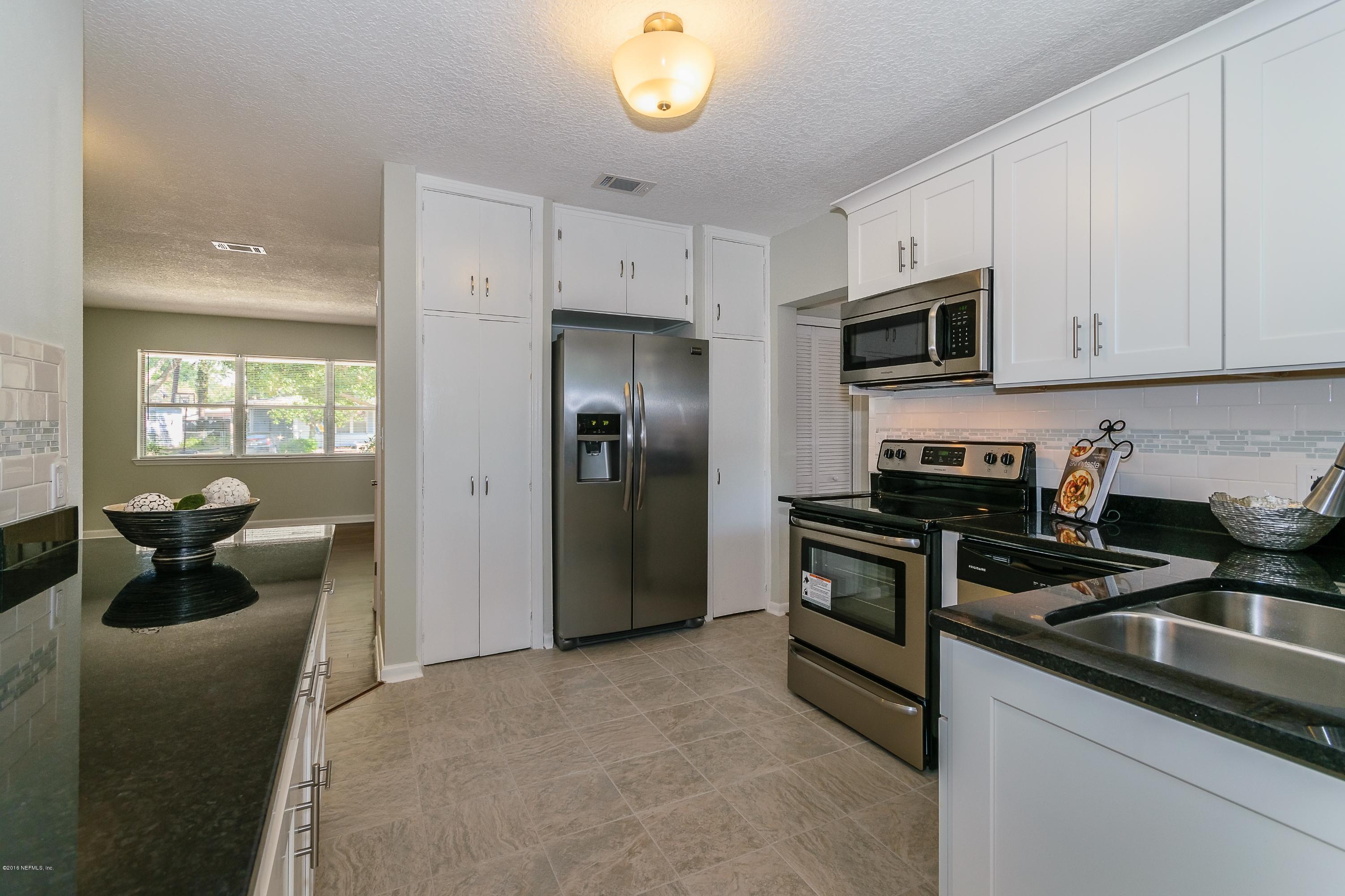6330 Wesleyan Road Jacksonville, FL 32217 - Photo 8 of 17 a kitchen with stainless steel appliances granite countertop a refrigerator stove top oven a sink and dishwasher