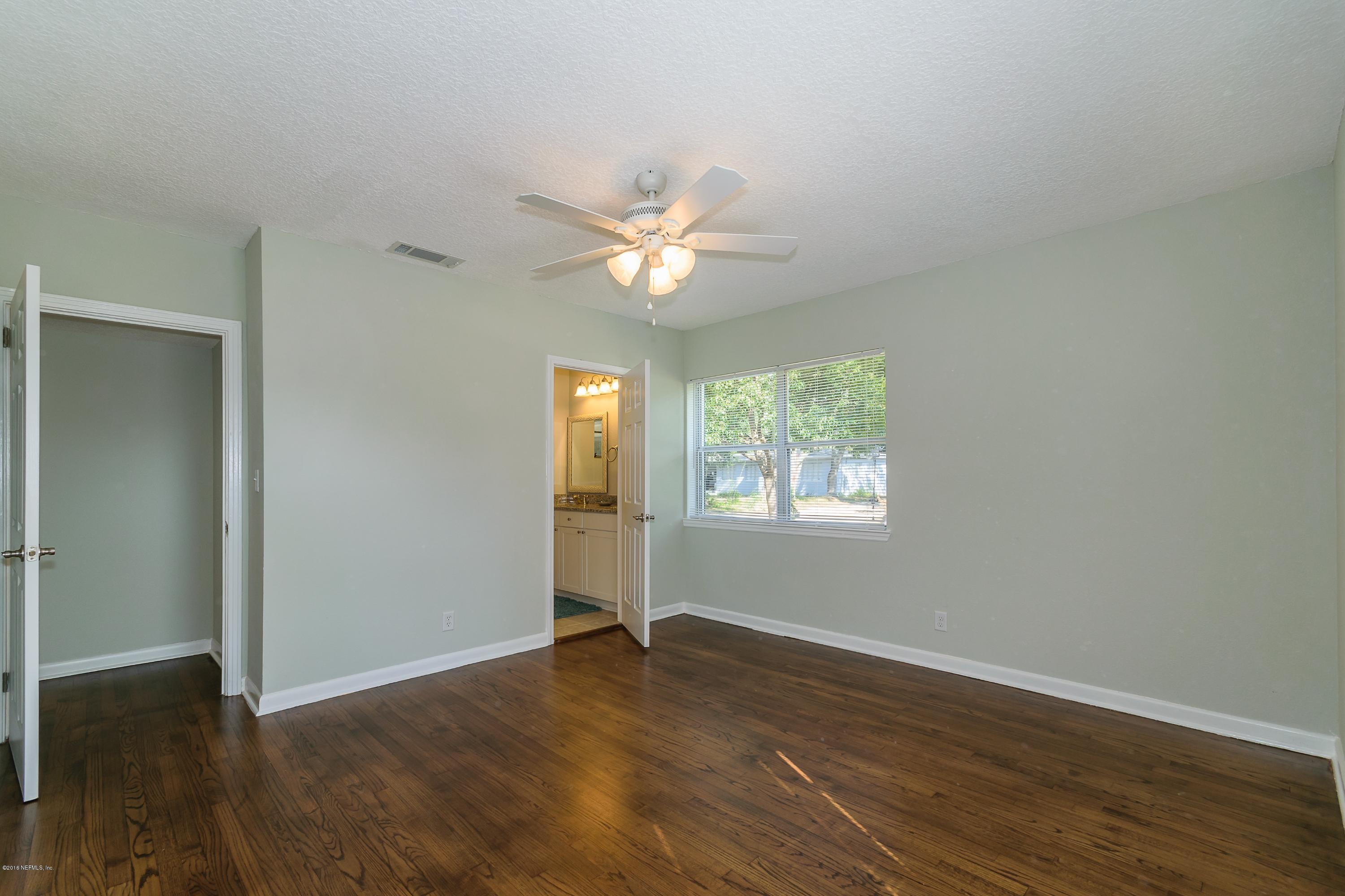 6330 Wesleyan Road Jacksonville, FL 32217 - Photo 10 of 17 an empty room with wooden floor and windows