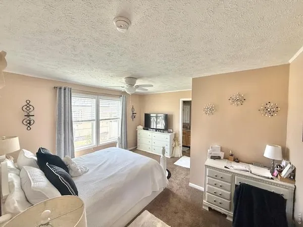 a bedroom with a bed and a couch