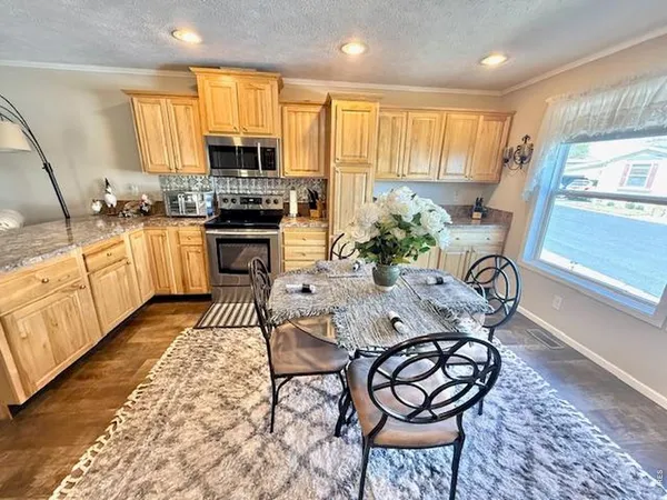 a kitchen with granite countertop lots of white furniture appliances and furniture