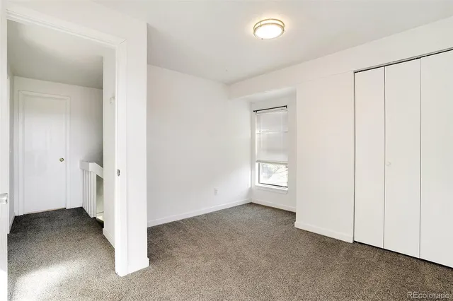a view of a room with window and wooden floor