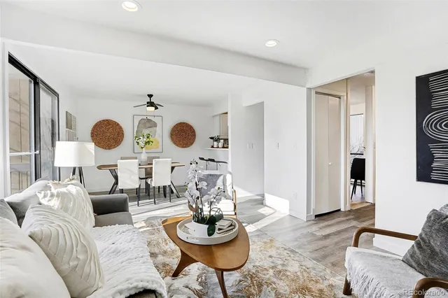 a living room with fireplace furniture and a large window