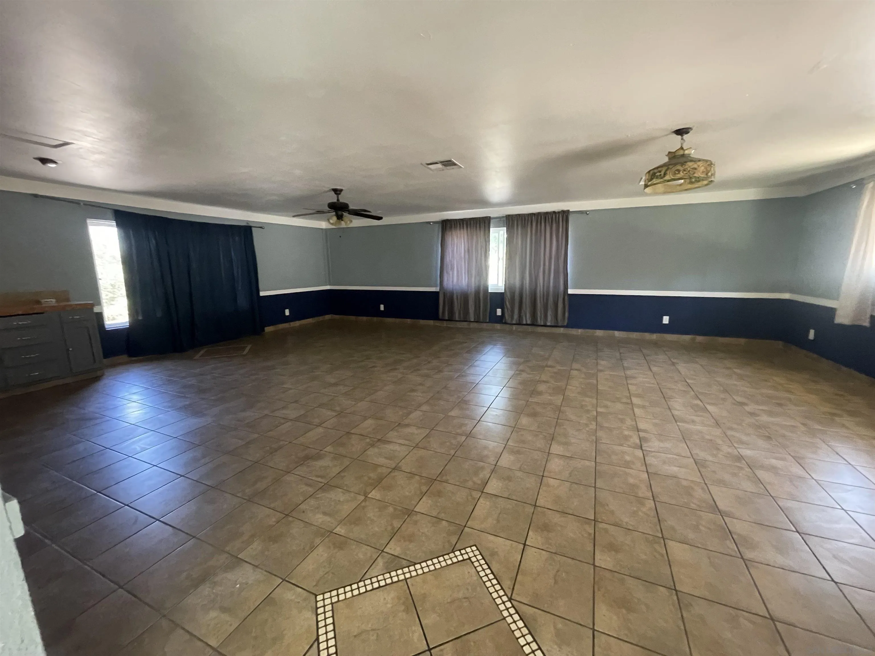 2248 La Cresta Road El Cajon, CA 92021 - Photo 8 of 11 an empty room with a ceiling fan and windows