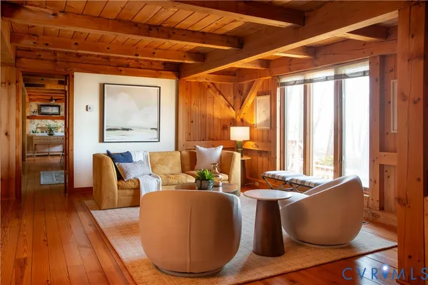 a living room with furniture and large window