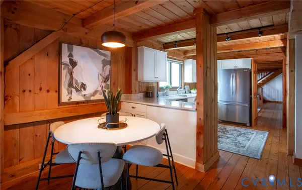 a dining room with furniture and wooden floor