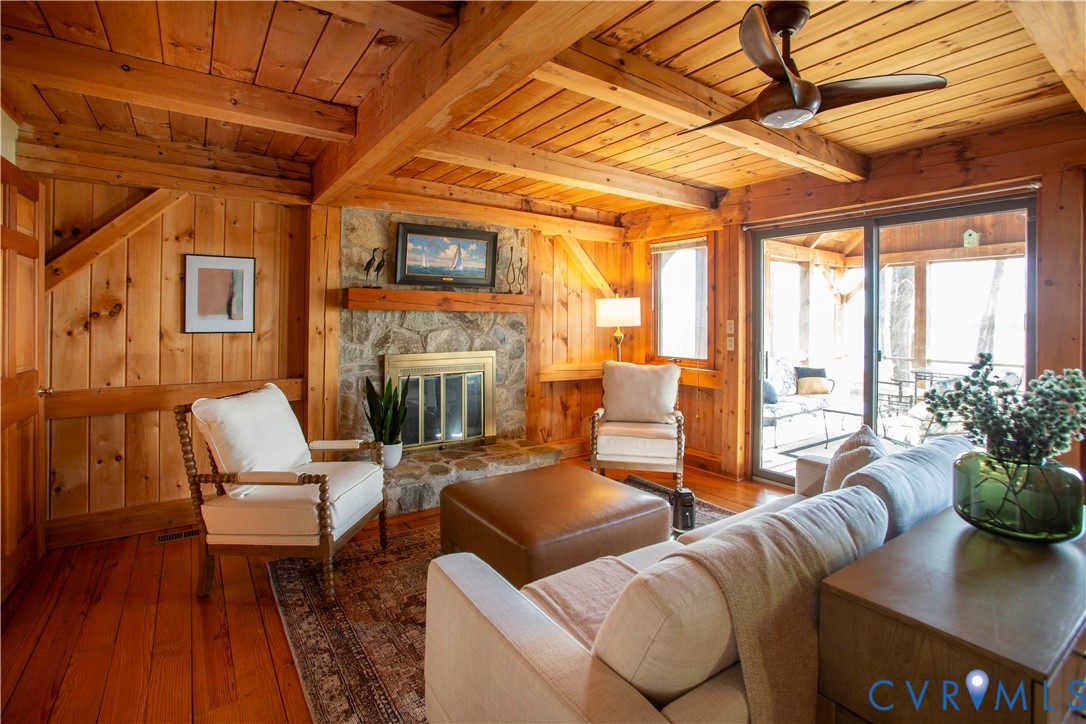 877 Twiggs Ferry Road Hartfield, VA 23071 - Photo 17 of 34 a living room with furniture a fireplace and a table