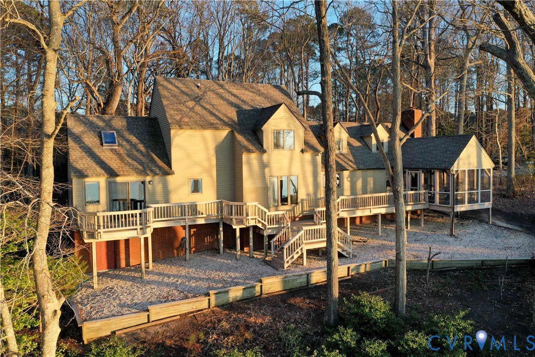 877 Twiggs Ferry Road Hartfield, VA 23071 - Photo 2 of 34 a view of a patio with couches table and chairs and potted plants