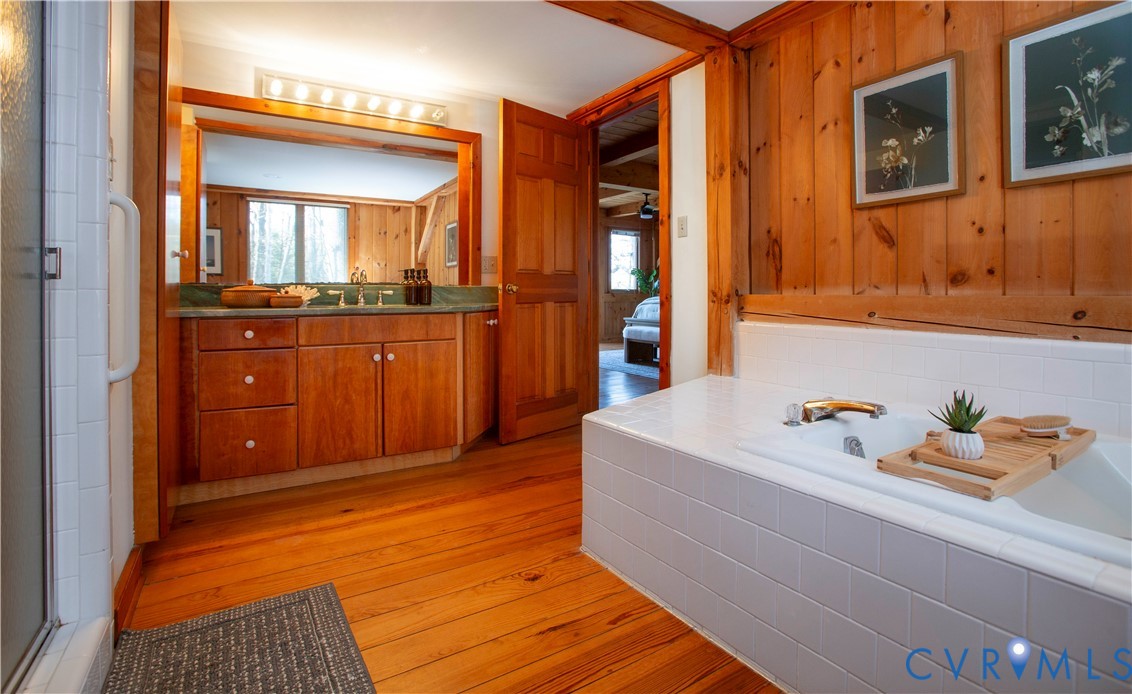 877 Twiggs Ferry Road Hartfield, VA 23071 - Photo 21 of 34 a bathroom with a tub sink and mirror