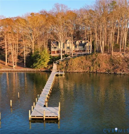 a view of residential house with outdoor space and lake