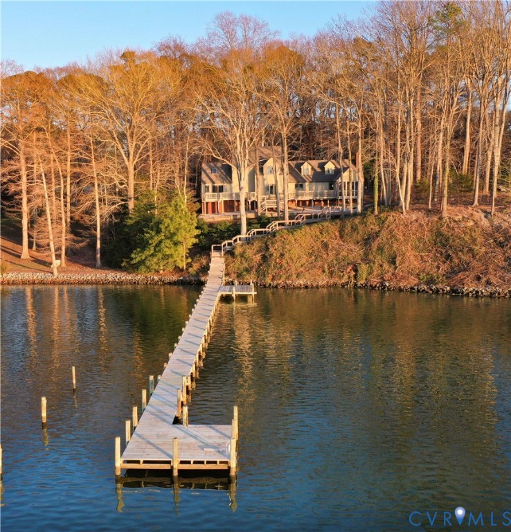 877 Twiggs Ferry Road Hartfield, VA 23071 - Photo 3 of 34 a view of residential house with outdoor space and lake