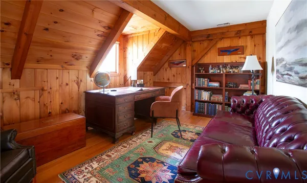 a living room with furniture a rug and a window