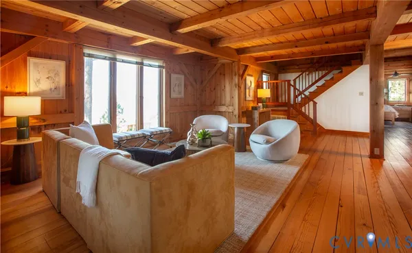 a living room with furniture and a wooden floor
