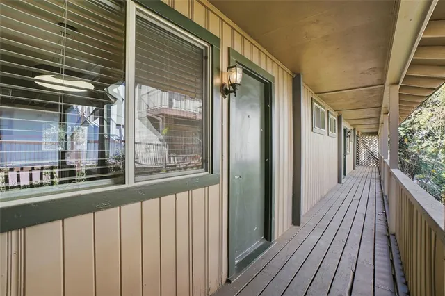 a view of a balcony with wooden floor
