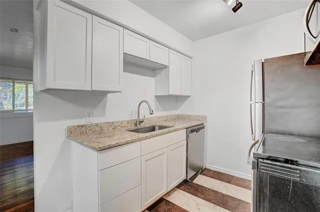 a kitchen with a sink and a refrigerator