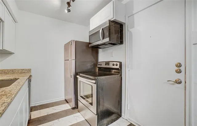 a kitchen with a stove microwave and refrigerator