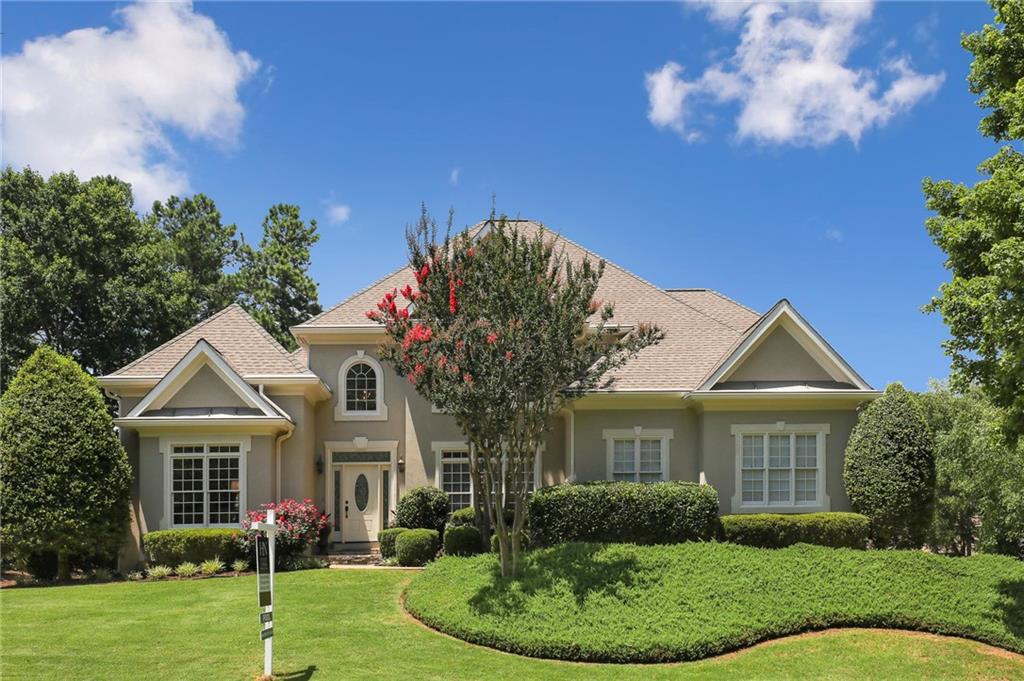 Beautiful European traditional hard coat stucco home in sought after Brookstone Country Club!