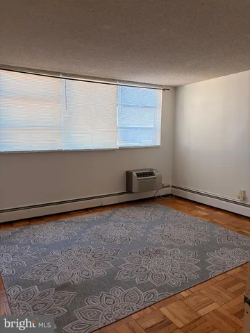 a view of a room with an empty space and window