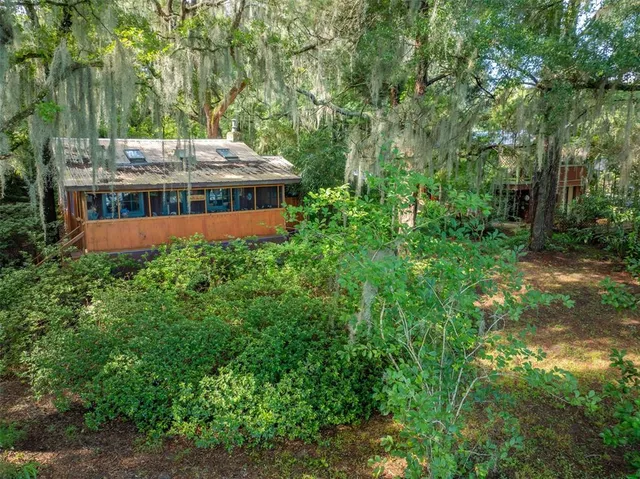 a backyard of a house with lots of green space and plants