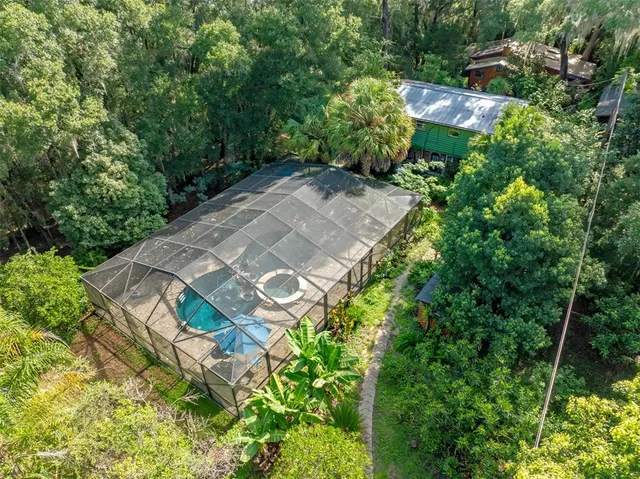 a view of a porch with wooden floor and backyard