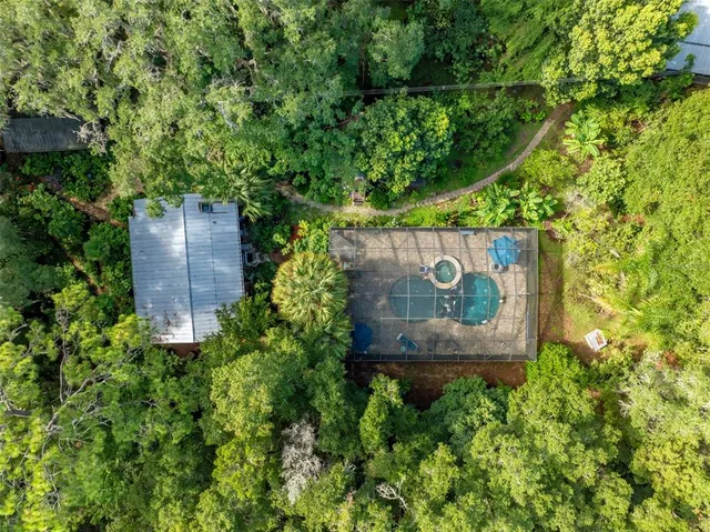 an aerial view of a house with a yard