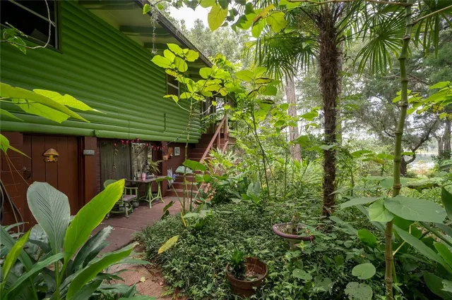 a view of a house with yard and sitting area