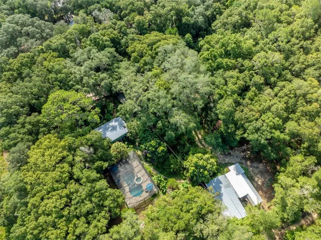 a kitchen with a sink and large windows