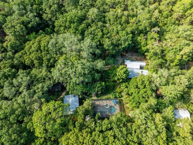 a view of a livingroom with a fireplace a chandelier and wooden floor