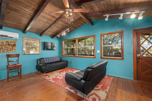 a view of a porch with furniture and wooden floor