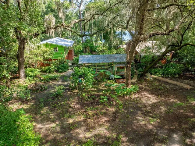 a view of backyard with outdoor seating and trees