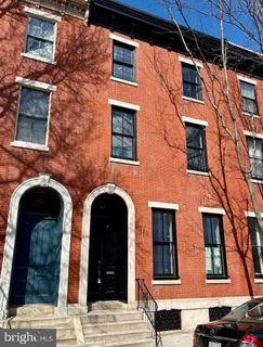 a view of a brick building with many windows