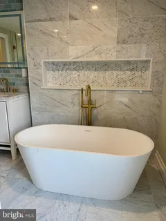 a white bath tub sitting in a bathroom