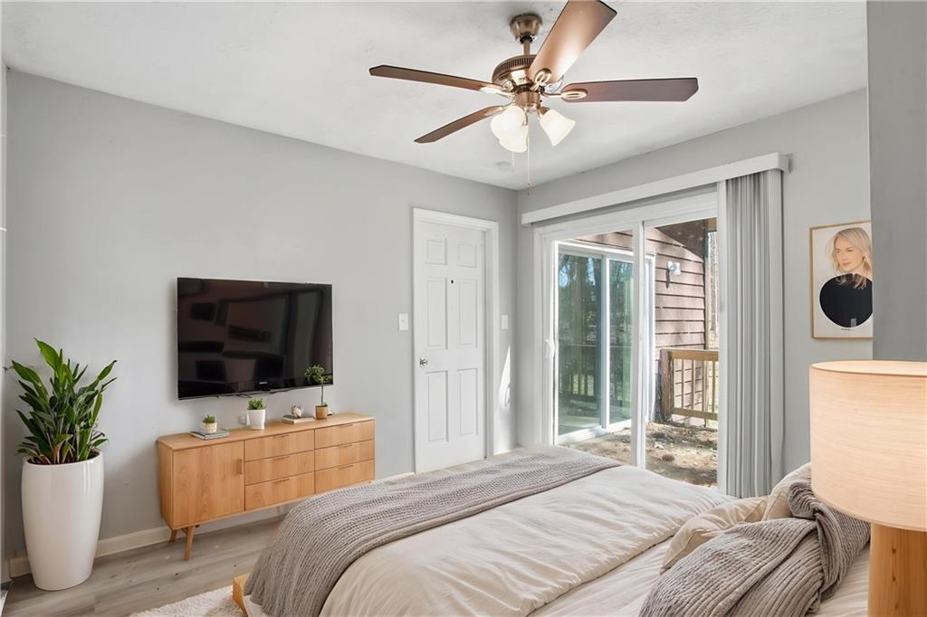 720 Twin Pines Road Covington, GA 30014 - Photo 11 of 40 a bedroom with a bed and a flat screen tv