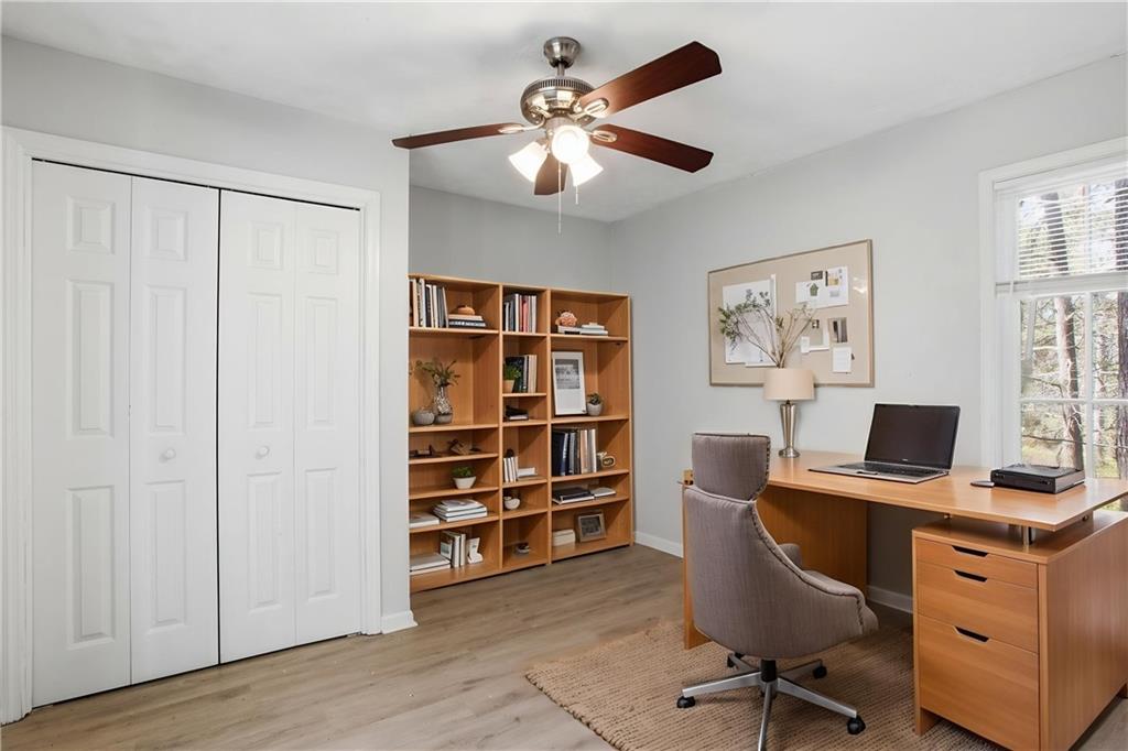 720 Twin Pines Road Covington, GA 30014 - Photo 12 of 40 a view of a workspace with furniture and a window