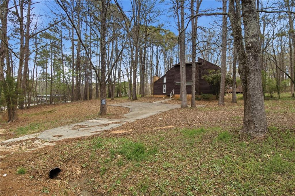 720 Twin Pines Road Covington, GA 30014 - Photo 2 of 40 a view of road with large trees