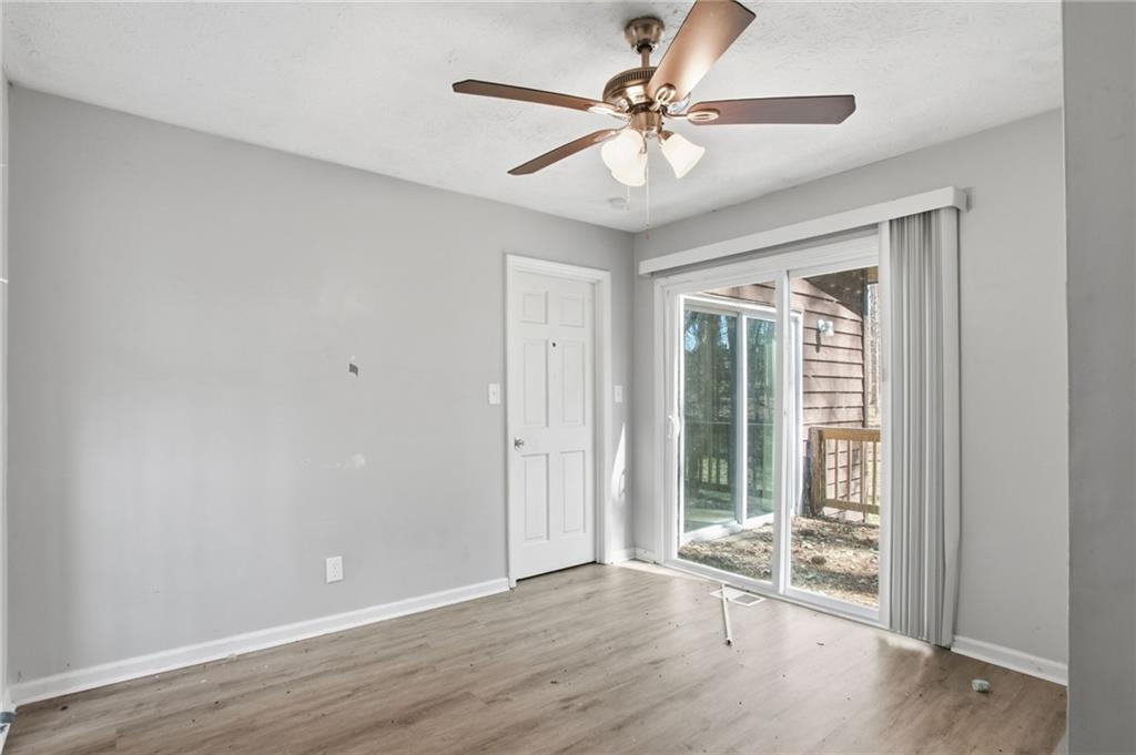 720 Twin Pines Road Covington, GA 30014 - Photo 24 of 40 a view of an empty room with wooden floor and a window