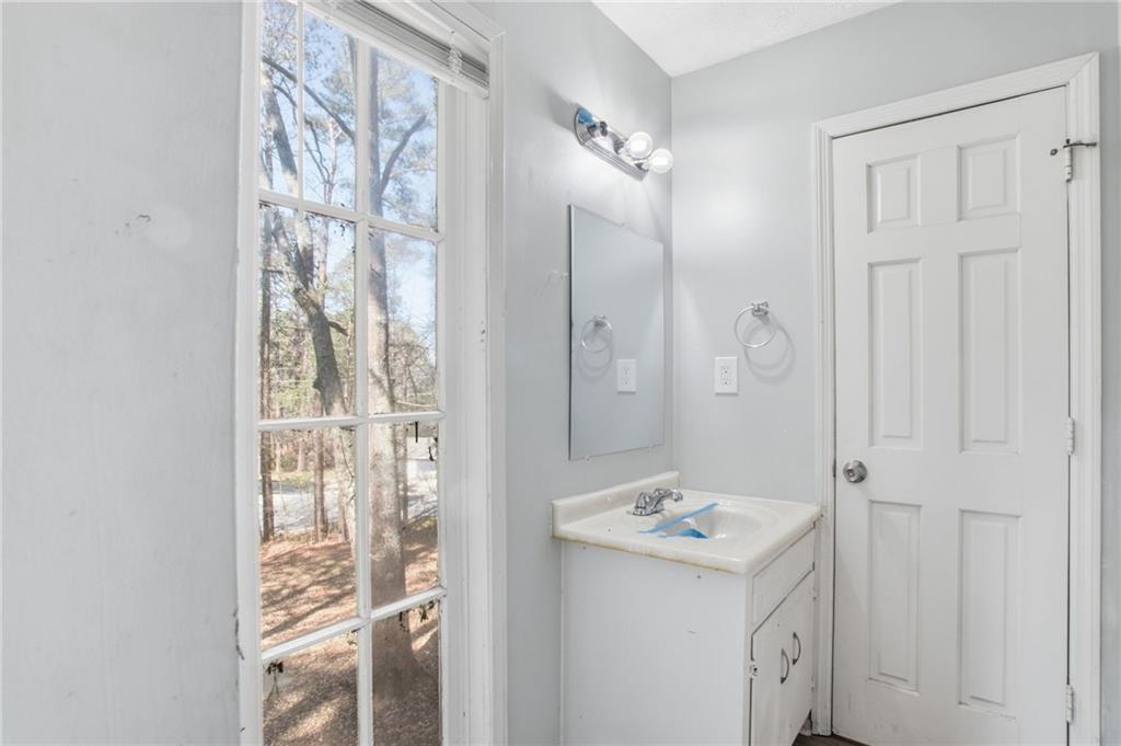 720 Twin Pines Road Covington, GA 30014 - Photo 31 of 40 a bathroom with a sink a mirror and a shower