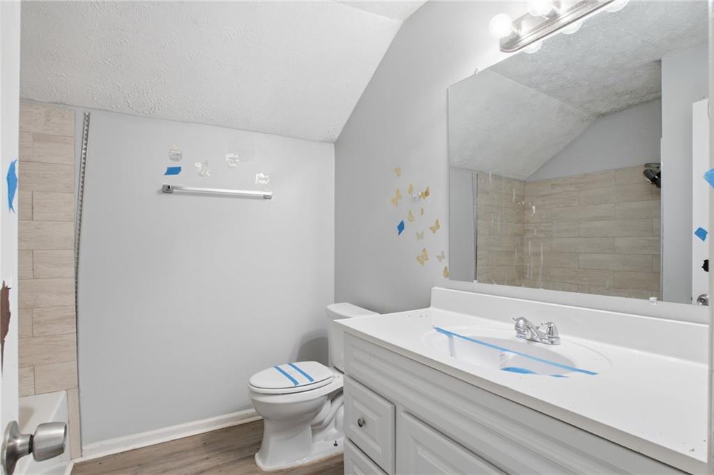720 Twin Pines Road Covington, GA 30014 - Photo 33 of 40 a bathroom with a granite countertop toilet and a sink