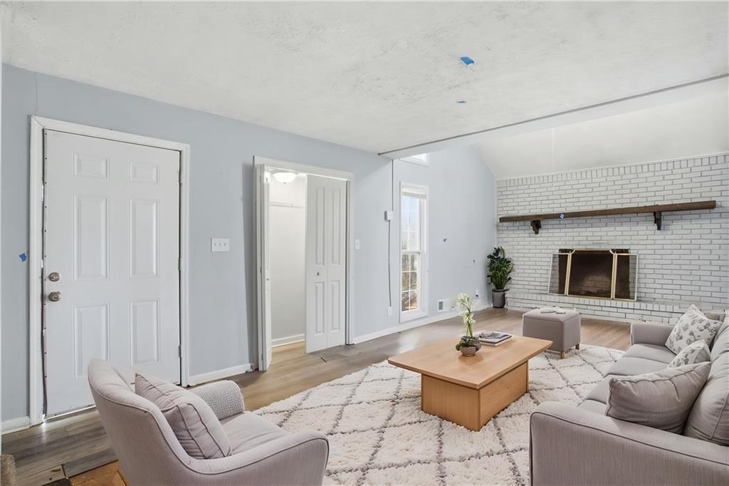 720 Twin Pines Road Covington, GA 30014 - Photo 5 of 40 a living room with furniture and a flat screen tv