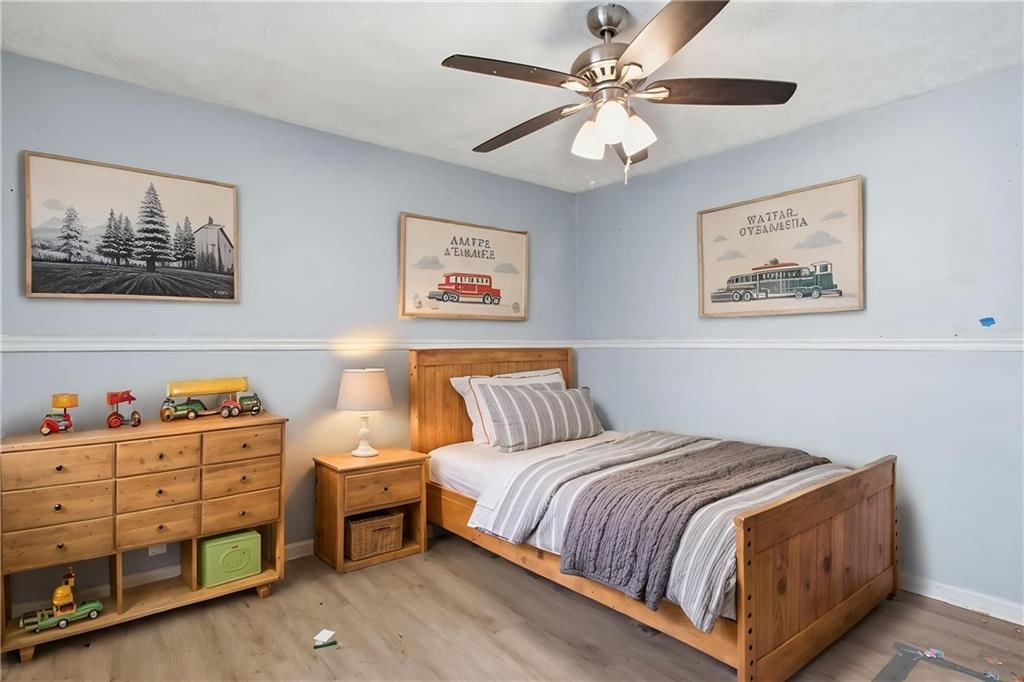 720 Twin Pines Road Covington, GA 30014 - Photo 10 of 40 a bedroom with a bed and a painting on the wall